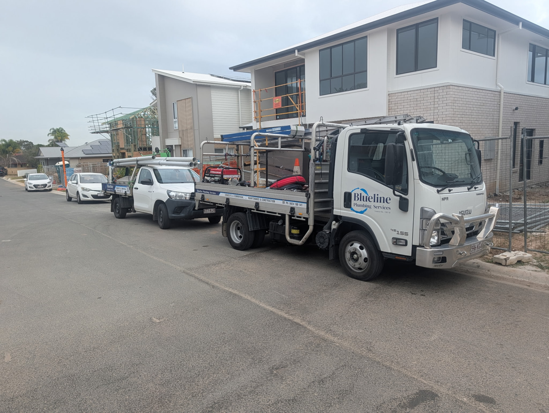 Blueline Plumbing Services fleet working across a housing development