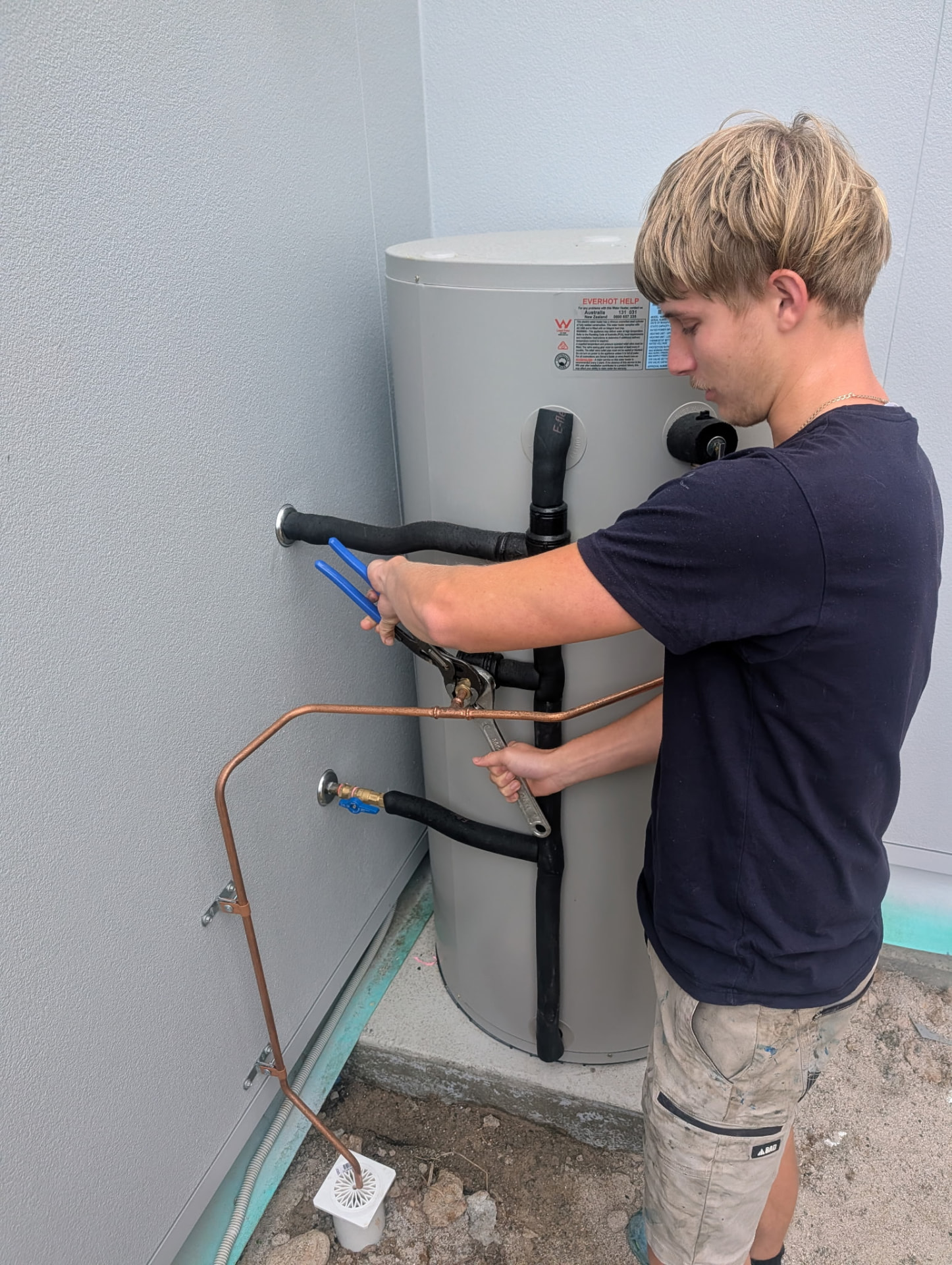 Blueline team member completing hot water system pipework